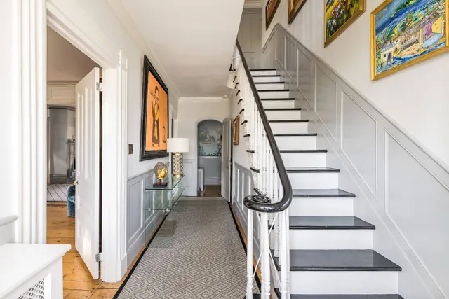 a view of entryway and hall with wooden floor