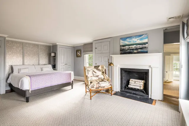 a bedroom with a bed and a fireplace