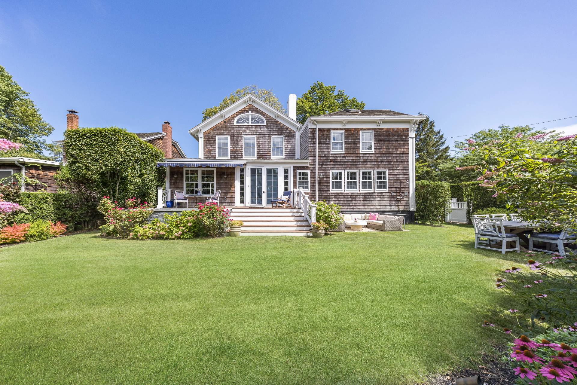 330 Main Street Sag Harbor, NY 11963 - Photo 2 of 32 a front view of a house with a garden