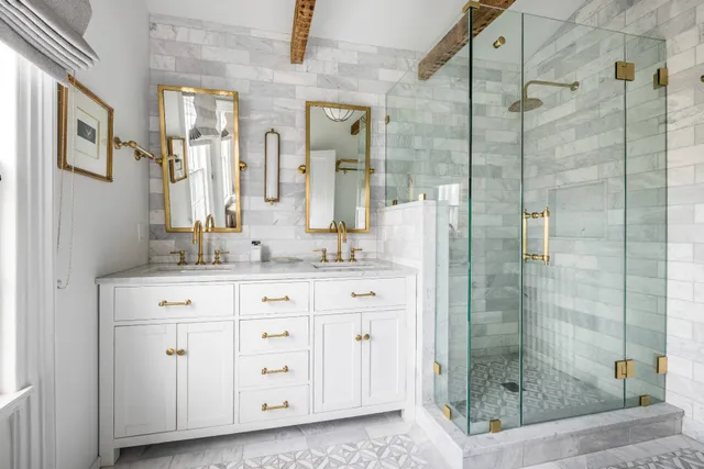 a bathroom with a granite countertop shower sink and mirror