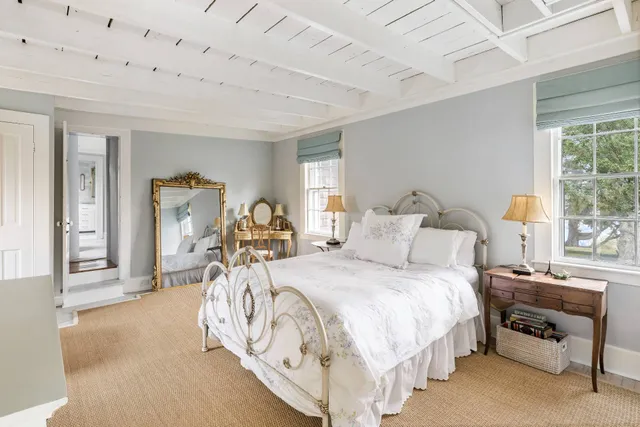 a bed room with a bed and a chair