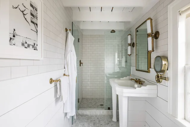 a bathroom with a shower sink and mirror