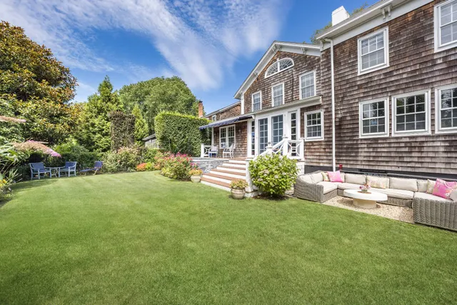a view of a house with a yard and a garden