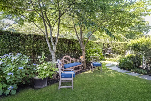 a view of a chairs and table in the garden