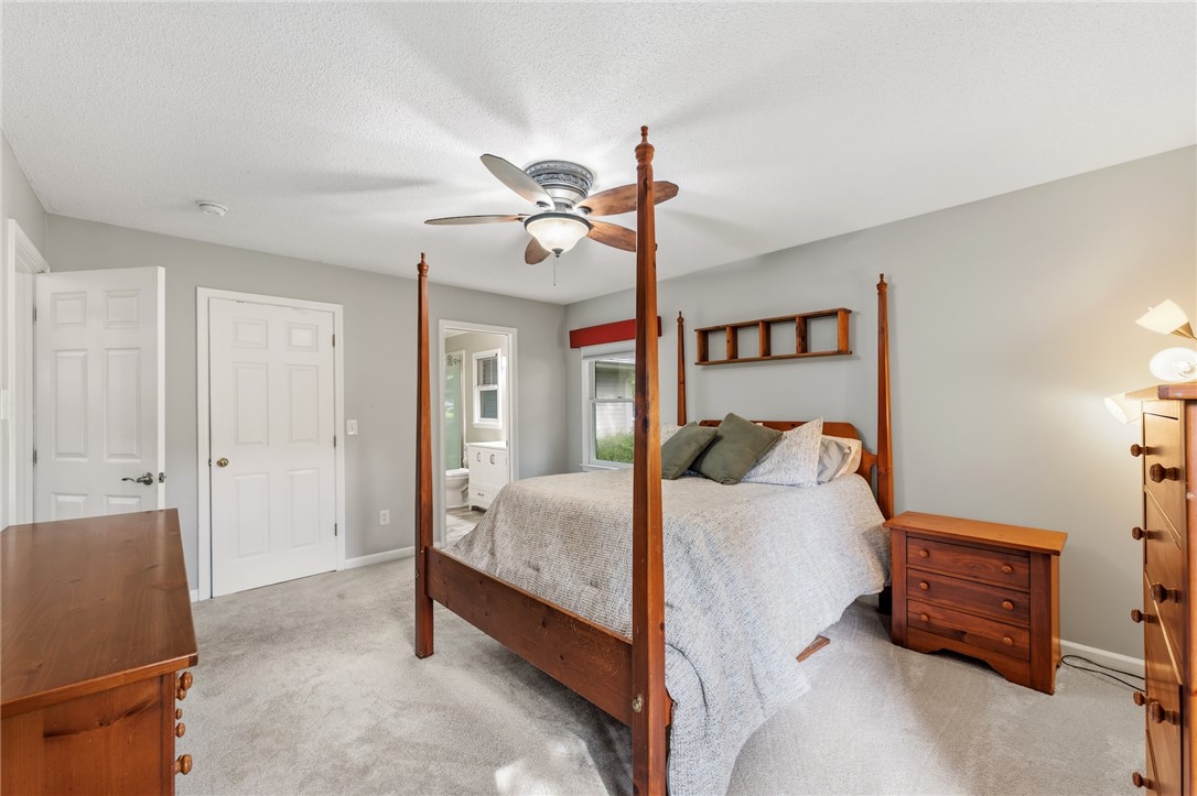 1014 East Queen Street Pendleton, SC 29670 - Photo 25 of 43 A tranquil bedroom retreat features soft gray walls, plush carpeting, and a four-poster bed.