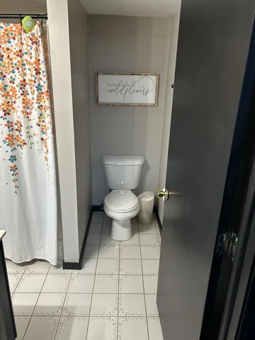 a bathroom with a toilet and a shower