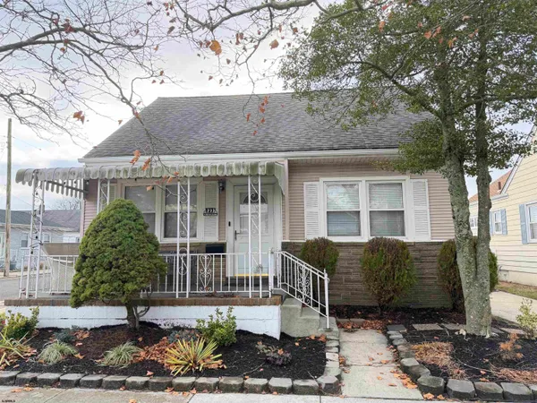a kitchen with stainless steel appliances kitchen island granite countertop a refrigerator a stove a sink dishwasher a dining table and chairs with wooden floor