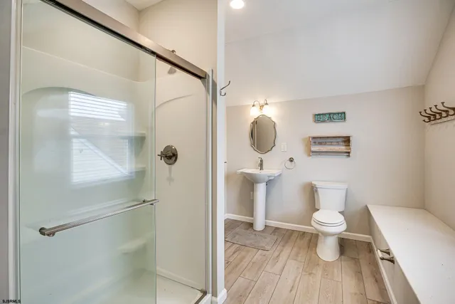 a bathroom with a toilet and a shower