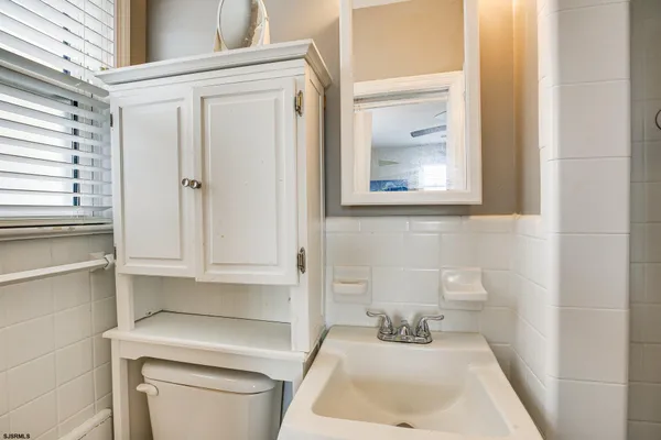 a bathroom with a sink a toilet and vanity
