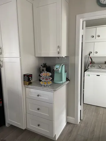 a utility room with cabinets washer and dryer