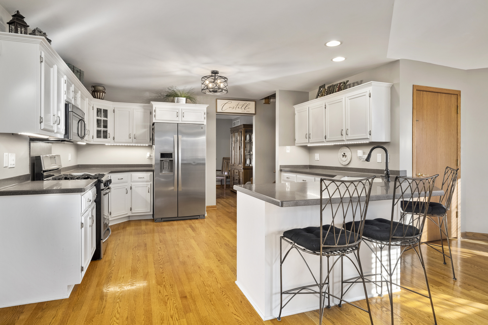 21181 Deerpath Road Frankfort, IL 60423 - Photo 12 of 25 a kitchen with stainless steel appliances kitchen island granite countertop a refrigerator and cabinets
