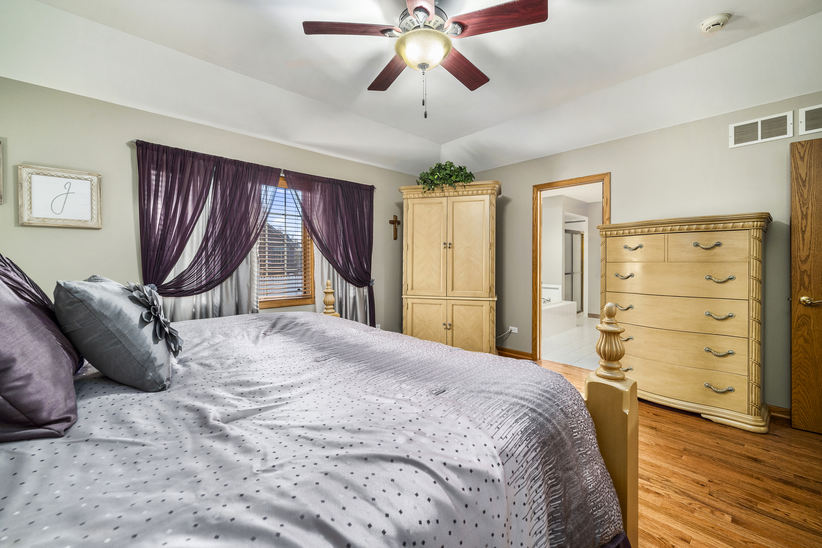 21181 Deerpath Road Frankfort, IL 60423 - Photo 17 of 25 a bed room with a bed and a chandelier
