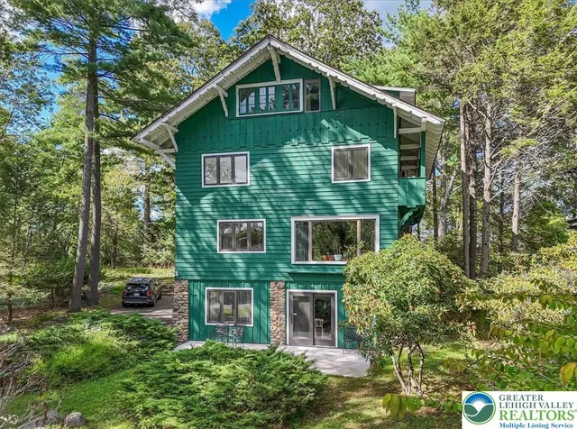 a view of a room with furniture and wooden floor