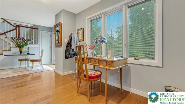 a kitchen with stainless steel appliances granite countertop white cabinets and a window