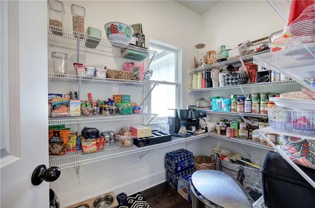 a bedroom with bed and wooden floor