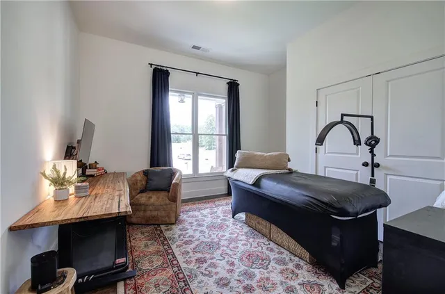 a bedroom with a bed and a chandelier