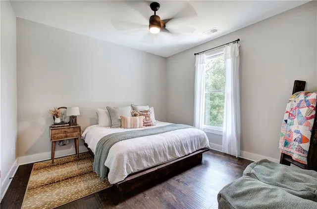 a bedroom with two beds and painting on the wall