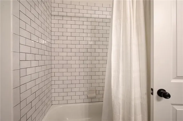 a bathroom with a sink a mirror and a shower