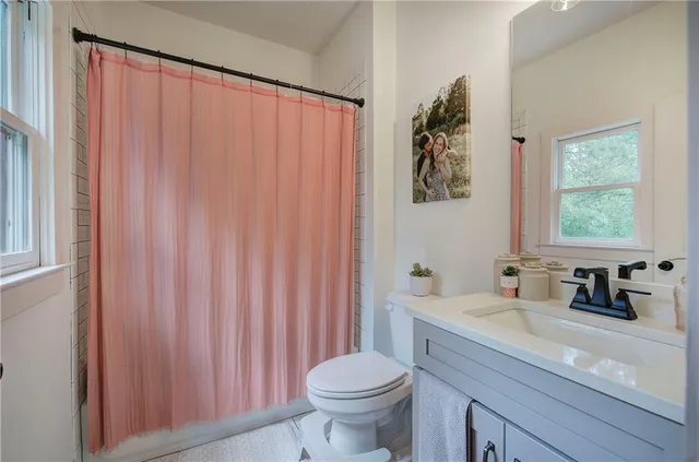 a bathroom with a double vanity sink a mirror and shower