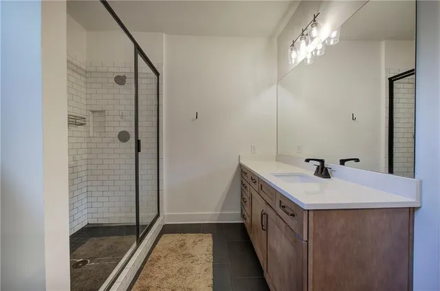 a living room with furniture a flat screen tv and a floor to ceiling window