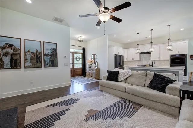 a living room with furniture and a chandelier