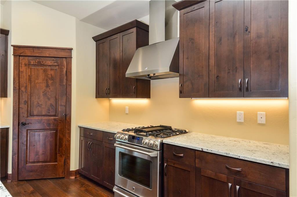 64 Erickson Loop, Unit 12B Keystone, CO 80435 - Photo 3 of 15 a kitchen with granite countertop wood cabinets and stainless steel appliances
