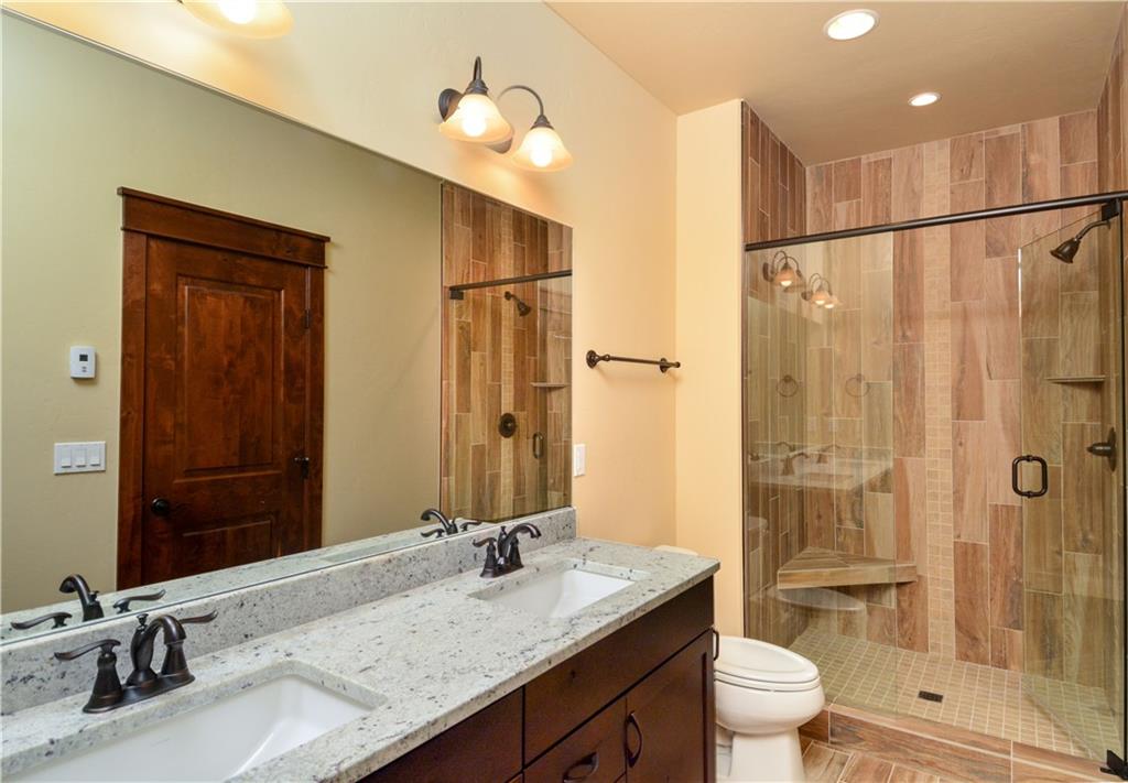 64 Erickson Loop, Unit 12B Keystone, CO 80435 - Photo 8 of 15 a bathroom with a granite countertop sink toilet and shower