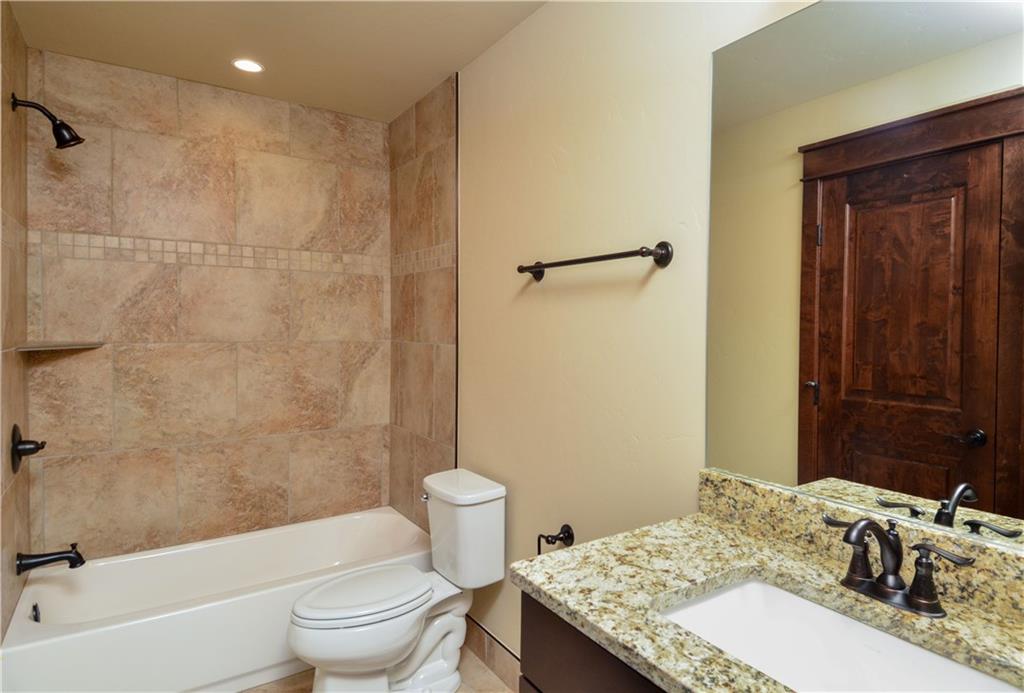 64 Erickson Loop, Unit 12B Keystone, CO 80435 - Photo 9 of 15 a bathroom with a granite countertop sink toilet and shower