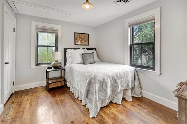 a bedroom with a bed and wooden floor