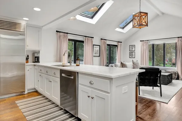 a spacious bathroom with a vanity a sink a large mirror and a shower