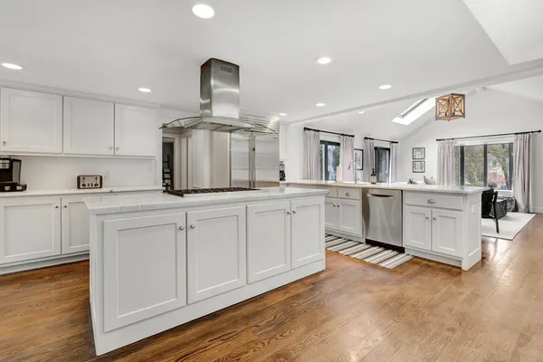 a view of a dining room with furniture wooden floor and chandelier