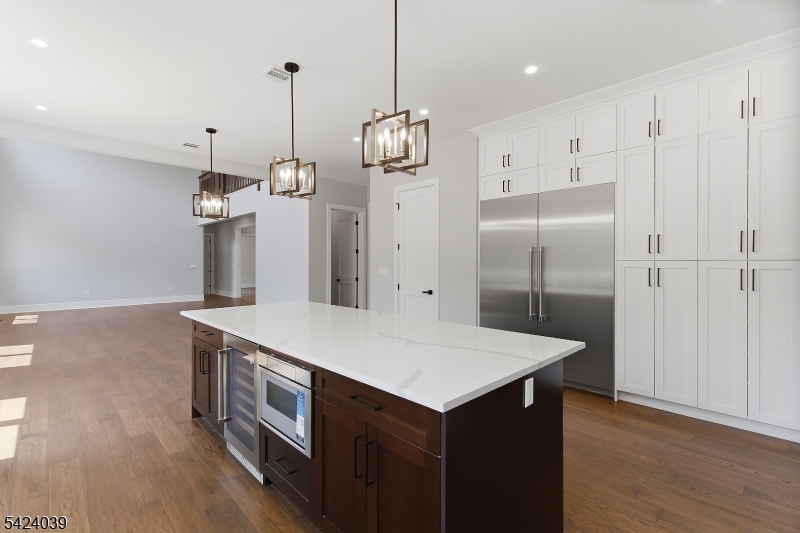 45 Kildee Road Belle Mead, NJ 08502 - Photo 10 of 43 a kitchen with stainless steel appliances a stove a refrigerator and a wooden floor