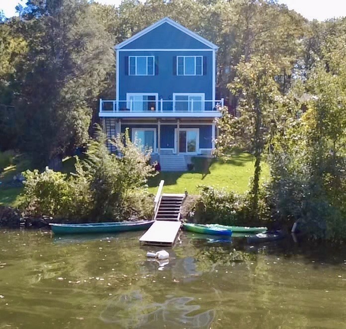 a view of a house with a yard and a swimming pool