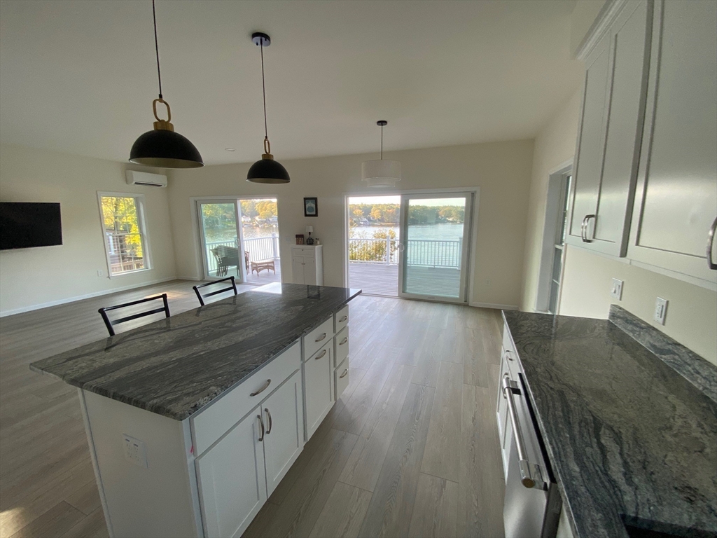 38 Stevens Park Road Charlton, MA 01507 - Photo 11 of 40 a kitchen with stainless steel appliances granite countertop a sink a stove and a wooden floors