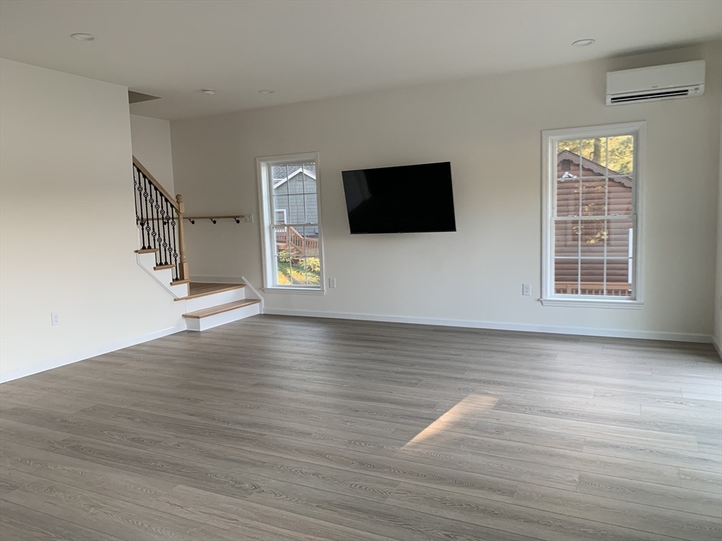 38 Stevens Park Road Charlton, MA 01507 - Photo 14 of 40 a view of a livingroom with wooden floor and a flat screen tv