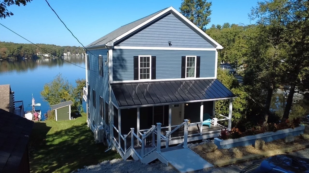 38 Stevens Park Road Charlton, MA 01507 - Photo 3 of 40 a view of house with backyard outdoor seating and lake view