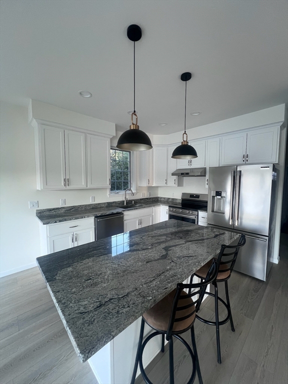 38 Stevens Park Road Charlton, MA 01507 - Photo 8 of 40 a kitchen with stainless steel appliances granite countertop a kitchen island a stove a table and chairs in it