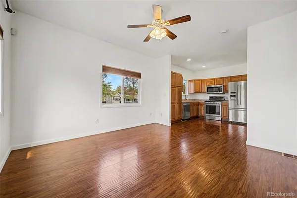 a view of kitchen with wooden floor and a window