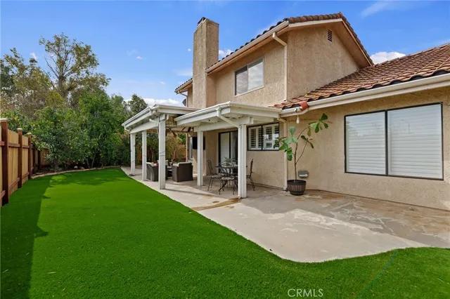 a front view of a house with a yard table and chairs