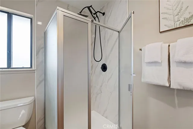a bathroom that has a glass shower door