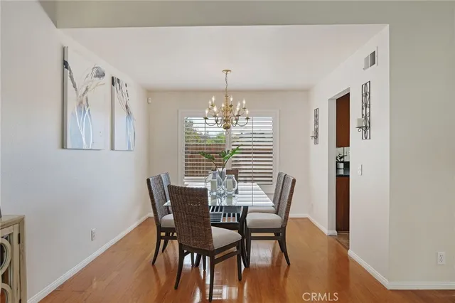 a view of a dining room with furniture and chandelier