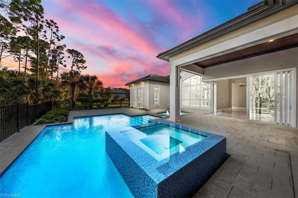 a swimming pool with outdoor seating and yard