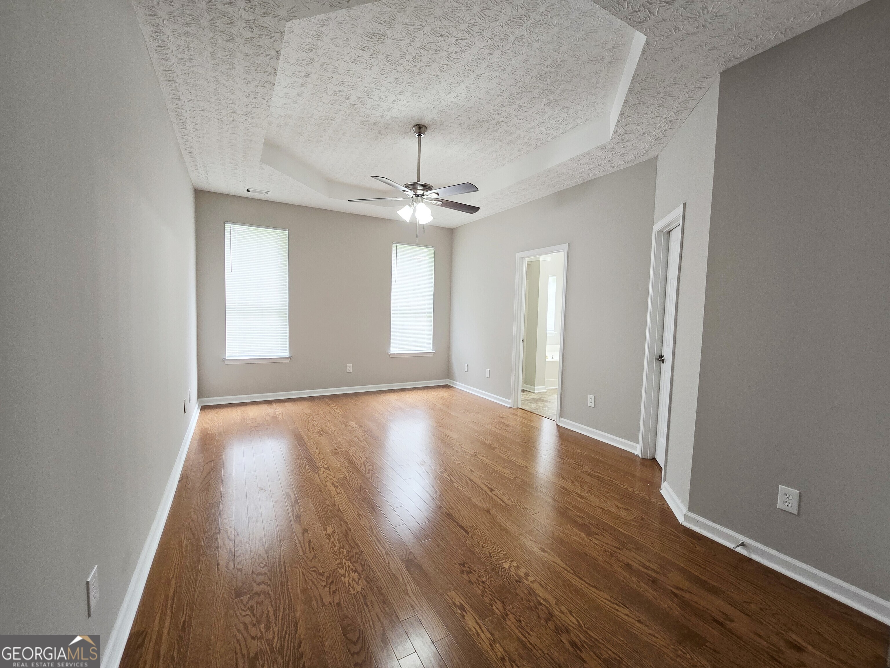 537 Goldfinch Way Stockbridge, GA 30281 - Photo 12 of 20 an empty room with wooden floor and windows