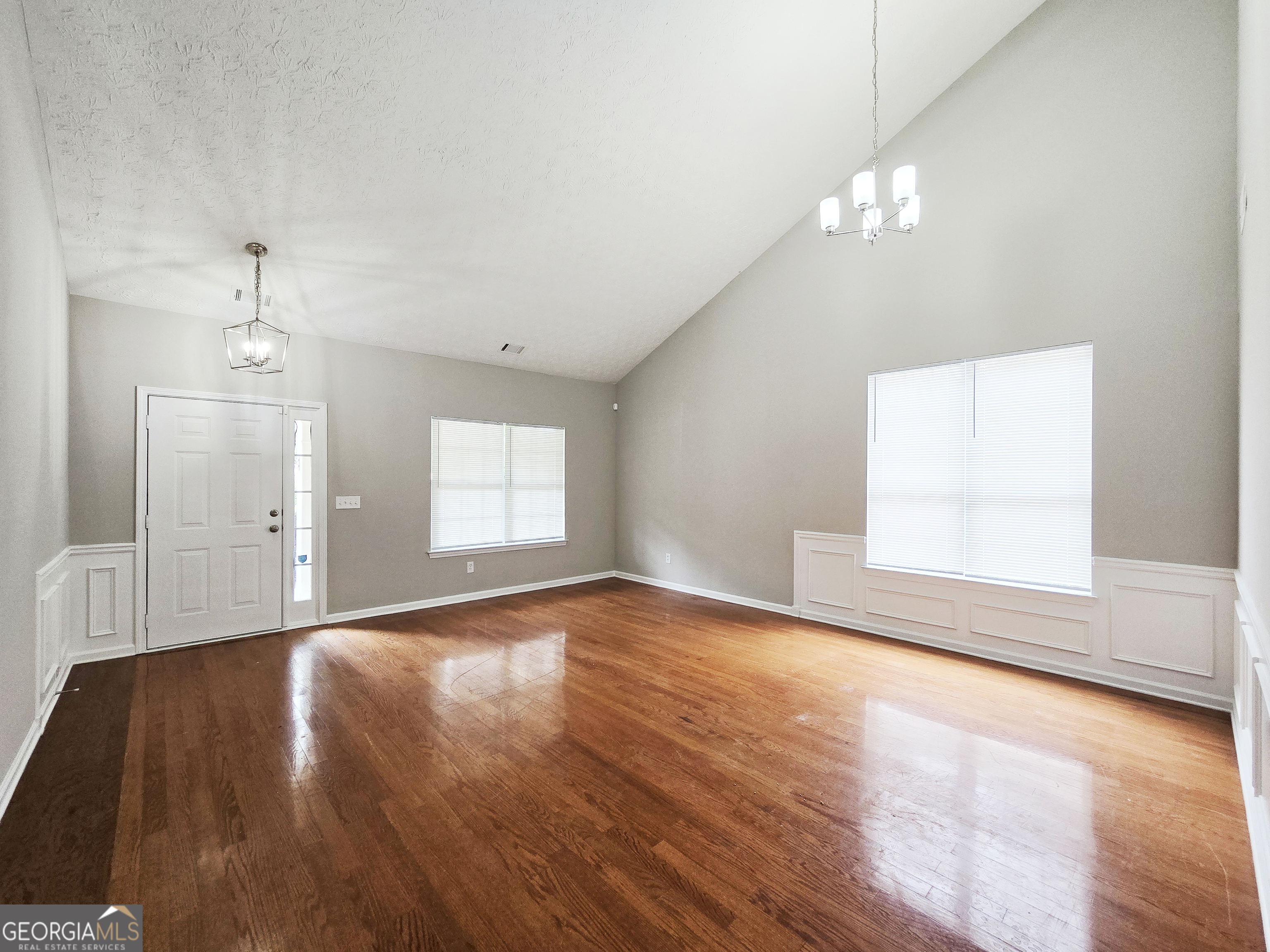 537 Goldfinch Way Stockbridge, GA 30281 - Photo 2 of 20 wooden floor in an empty room with a window