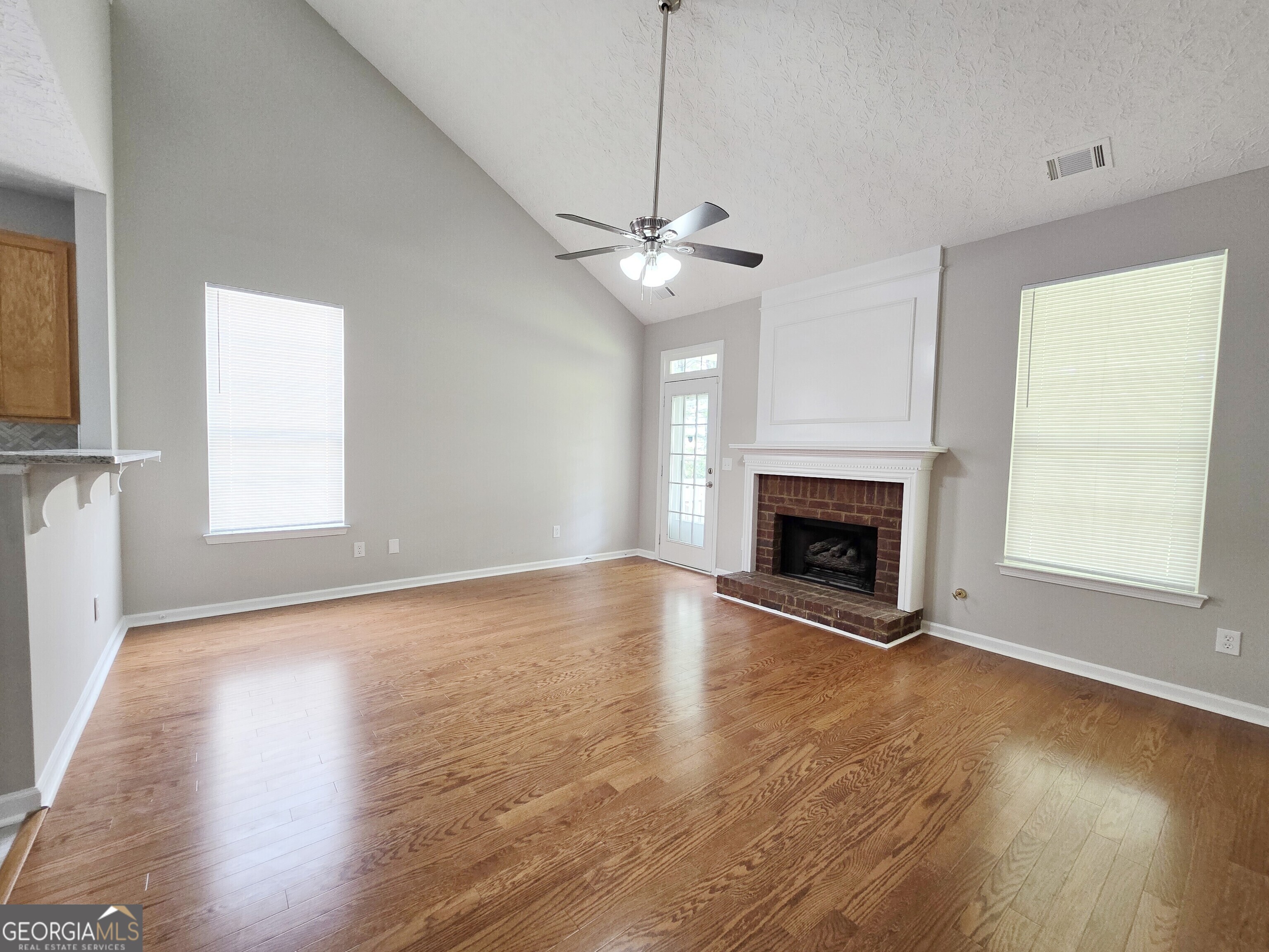 537 Goldfinch Way Stockbridge, GA 30281 - Photo 3 of 20 a view of empty room with wooden floor fireplace and window