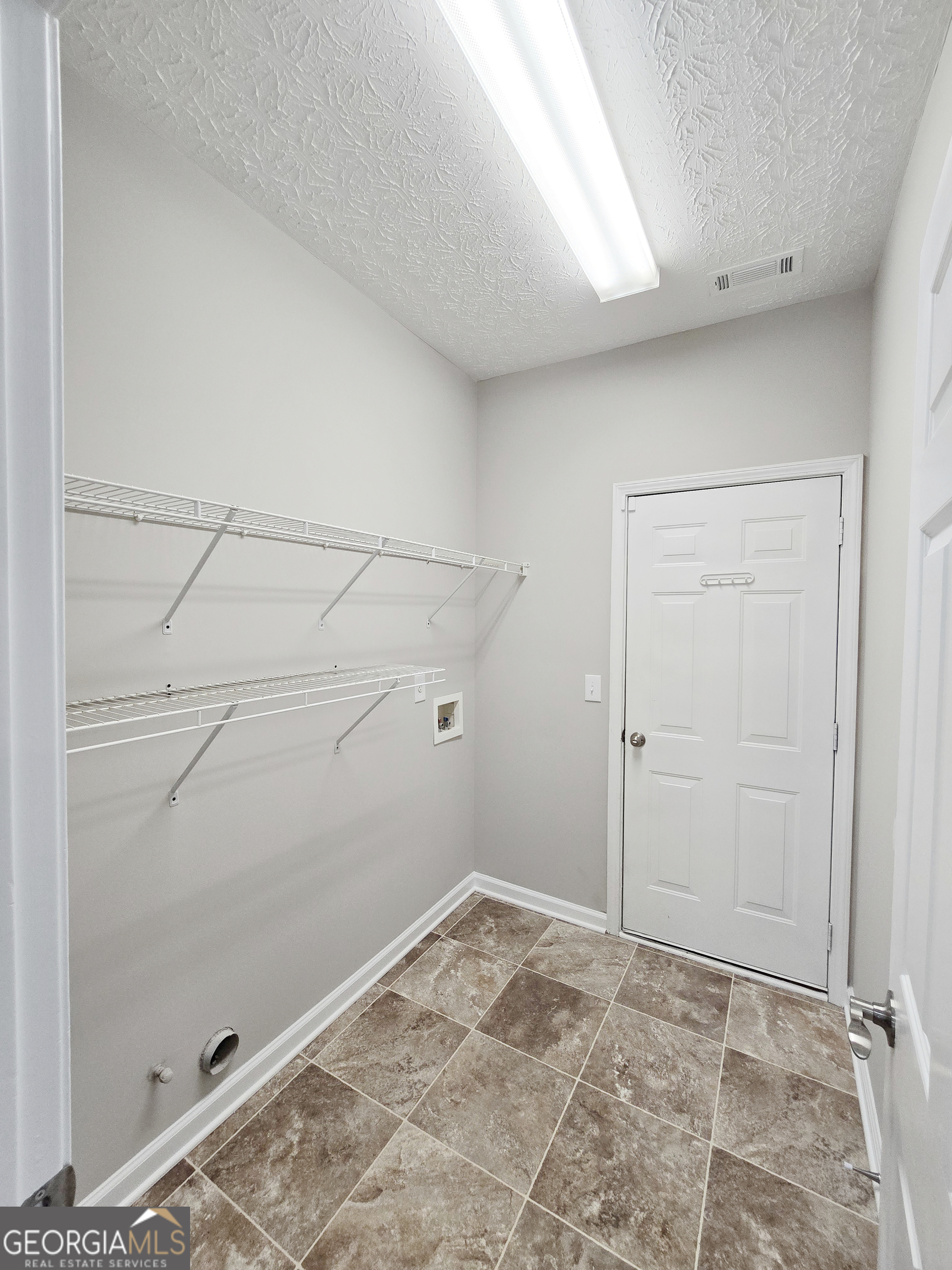 537 Goldfinch Way Stockbridge, GA 30281 - Photo 8 of 20 a view of a room with empty racks