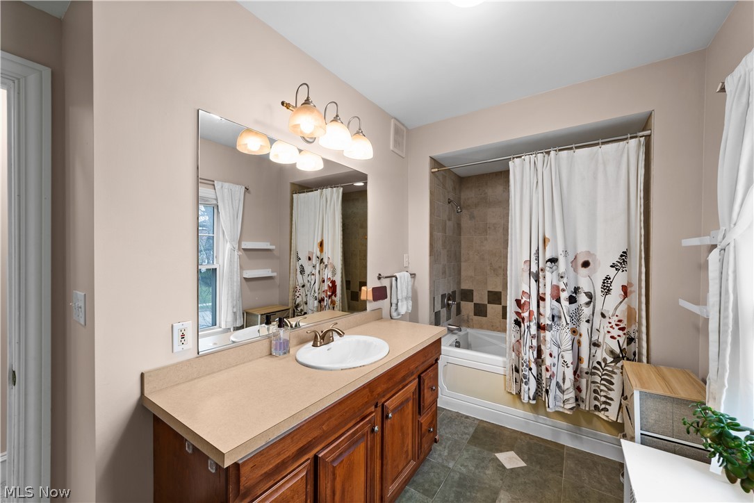 1680 Lee Road Cleveland, OH 44118 - Photo 27 of 45 Bathroom with tile floors, vanity, and shower / tub combo