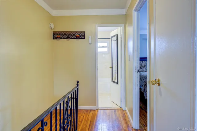 a view of a hallway with wooden floor and staircase