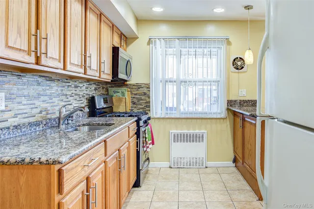 a kitchen with stainless steel appliances granite countertop a sink and a counter space