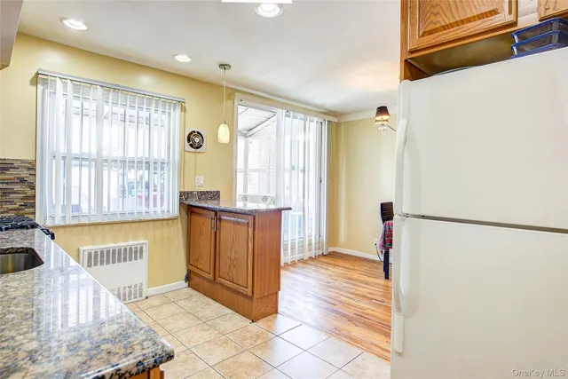 a view of a kitchen with a refrigerator cabinets and a window